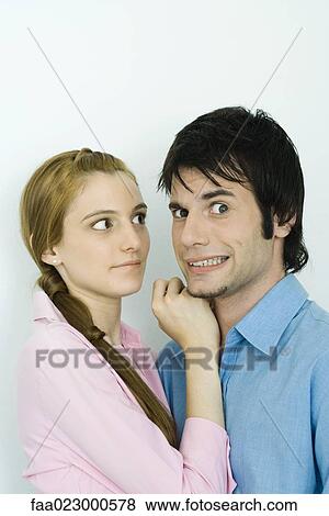 Young couple together, man making faces at camera, woman looking at man View Large Photo Image Stock Photo - Young couple together, man making faces at camera, woman looking at man. Fotosearch