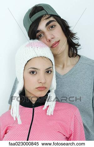 Young couple wearing hats, looking at camera, portrait View Large Photo Image Stock Photography - Young couple wearing hats, looking at camera, portrait. Fotosearch