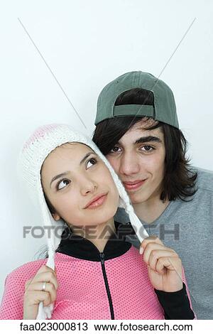 Young couple wearing hats, portrait View Large Photo Image Stock Image - Young couple wearing hats, portrait. Fotosearch