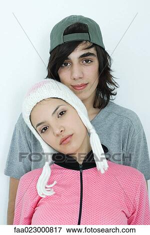 Stock Photo - Young couple wearing hats, portrait. Fotosearch