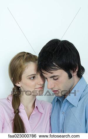 Young couple with heads close together, portrait View Large Photo Image Stock Photograph - Young couple with heads close together, portrait. Fotosearch
