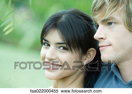 Young couple, woman smiling at camera, portrait View Large Photo Image Stock Photography - Young couple, woman smiling at camera, portrait. Fotosearch