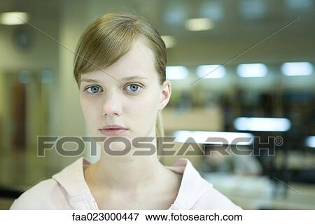 Young female college student in library, looking at camera, head and shoulders View Large Photo Image Stock Photo - Young female college student in library, looking at camera, head and shoulders. Fotosearch