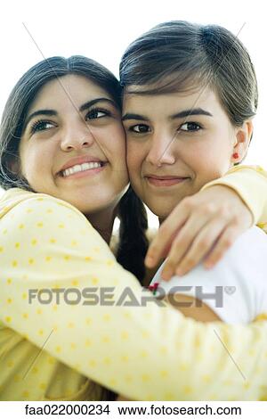 Young female friends hugging, portrait View Large Photo Image Picture - Young female friends hugging, portrait. Fotosearch