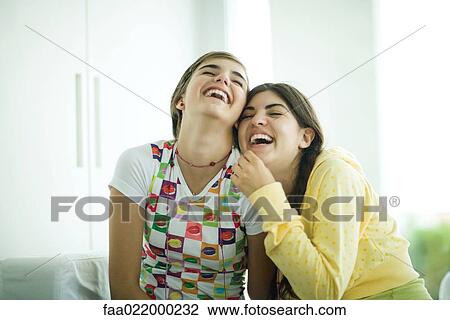 Young female friends laughing View Large Photo Image Stock Image - Young female friends laughing. Fotosearch