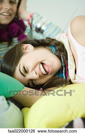 Young female friends laughing View Large Photo Image Stock Photograph - Young female friends laughing. Fotosearch