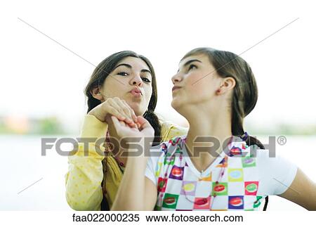 Young female friends posing, portrait View Large Photo Image Stock Photography - Young female friends posing, portrait. Fotosearch