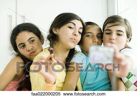 Young female friends with make-up looking at selves in hand mirror View Large Photo Image Stock Photography - Young female friends with make-up looking at selves in hand mirror. Fotosearch