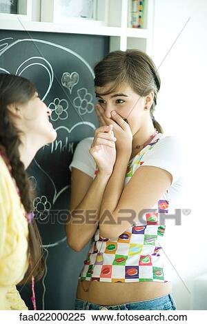 Young female friends writing names in hearts on chalkboard, laughing View Large Photo Image Stock Photography - Young female friends writing names in hearts on chalkboard, laughing. Fotosearch