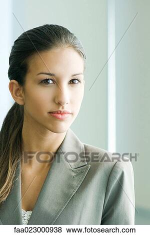 Young female in business attire looking at camera, portrait View Large Photo Image Stock Photo - Young female in business attire looking at camera, portrait. Fotosearch
