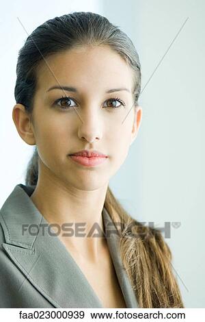 Young female in business attire looking at camera, portrait View Large Photo Image Stock Photo - Young female in business attire looking at camera, portrait. Fotosearch