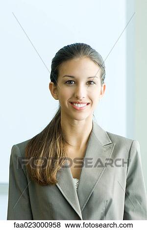 Young female in business attire smiling at camera, portrait View Large Photo Image Stock Photo - Young female in business attire smiling at camera, portrait. Fotosearch