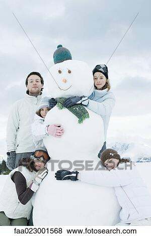 Young friends grouped around snowman, posing, portrait View Large Photo Image Stock Photo - Young friends grouped around snowman, posing, portrait. Fotosearch