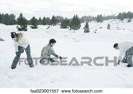 Stock Photo - Young friends having snowball fight. Fotosearch