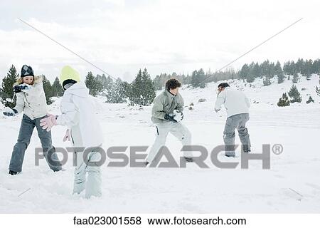Stock Photo - Young friends having snowball fight. Fotosearch