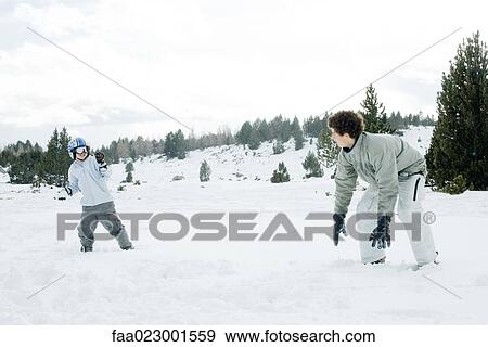 Young friends having snowball fight View Large Photo Image Stock Photo - Young friends having snowball fight. Fotosearch