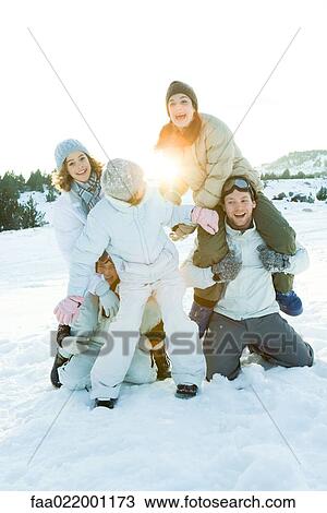 Young friends playing around in snow, group photo View Large Photo Image Stock Image - Young friends playing around in snow, group photo. Fotosearch
