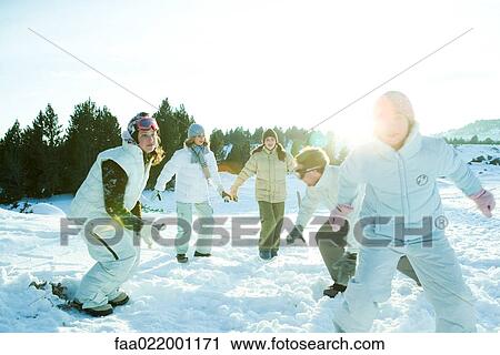 Young friends running in snow, dressed in winter clothing View Large Photo Image Stock Image - Young friends running in snow, dressed in winter clothing. Fotosearch