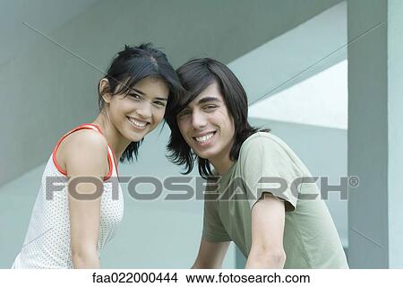 Young male and female friends, waist up, looking at camera View Large Photo Image Picture - Young male and female friends, waist up, looking at camera. Fotosearch