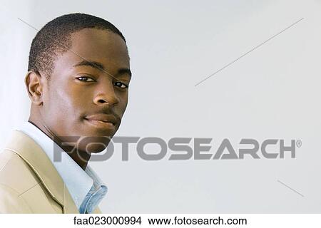 Young male looking at camera, portrait View Large Photo Image Picture - Young male looking at camera, portrait. Fotosearch
