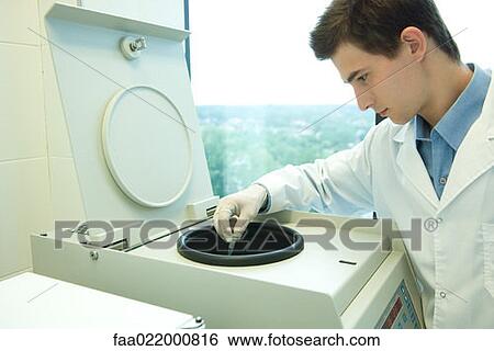 Young male researcher using centrifuge in laboratory, partial view View Large Photo Image Stock Photograph - Young male researcher using centrifuge in laboratory, partial view. Fotosearch