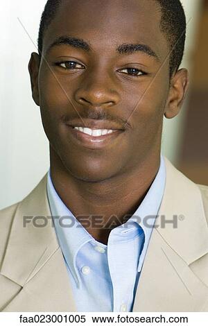 Young male smiling at camera, portrait View Large Photo Image Stock Photography - Young male smiling at camera, portrait. Fotosearch