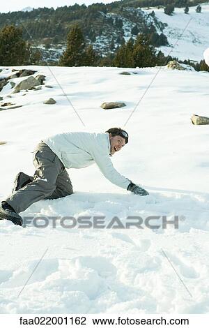 Young man down on all fours in snow, smiling, full length View Large Photo Image Stock Image - Young man down on all fours in snow, smiling, full length. Fotosearch