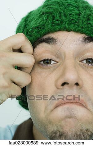 Young man frowning at camera, cropped view, close-up View Large Photo Image Stock Photo - Young man frowning at camera, cropped view, close-up. Fotosearch