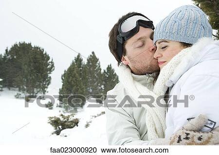 Young man kissing girlfriend, both with eyes closed, portrait View Large Photo Image Stock Image - Young man kissing girlfriend, both with eyes closed, portrait. Fotosearch