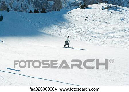 Young man snowboarding, high angle view View Large Photo Image Picture - Young man snowboarding, high angle view. Fotosearch