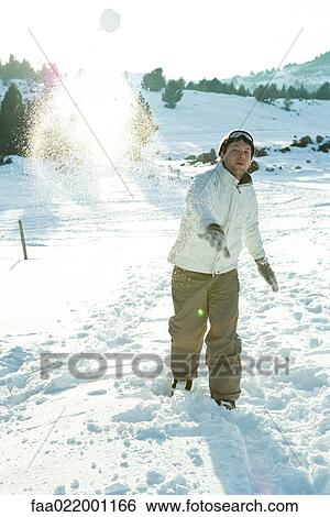 Young man throwing snowball, blurred motion, full length View Large Photo Image Stock Photograph - Young man throwing snowball, blurred motion, full length. Fotosearch