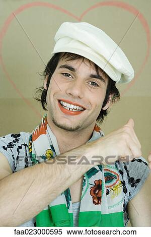 Young man wearing lipstick, cap, and scarf, smiling at camera, portrait View Large Photo Image Stock Photography - Young man wearing lipstick, cap, and scarf, smiling at camera, portrait. Fotosearch