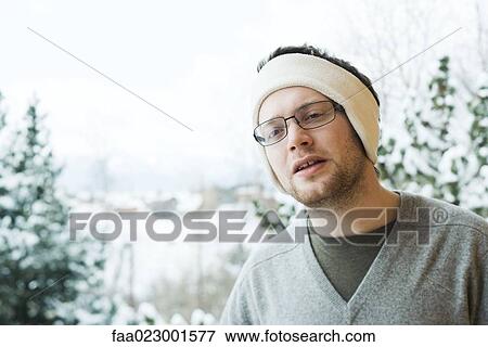 Young man wearing warm headband in snowy setting View Large Photo Image Stock Photo - Young man wearing warm headband in snowy setting. Fotosearch