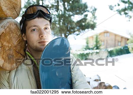 Young man with snowboard, portrait View Large Photo Image Stock Photography - Young man with snowboard, portrait. Fotosearch
