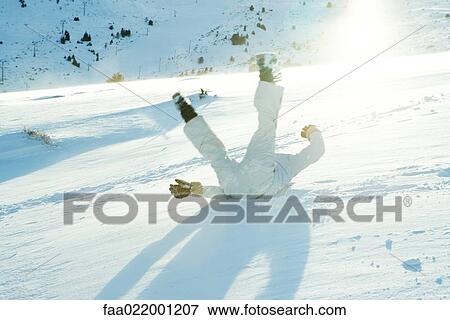 Young skier falling down ski slope, legs in the air, rear view View Large Photo Image Stock Photo - Young skier falling down ski slope, legs in the air, rear view. Fotosearch
