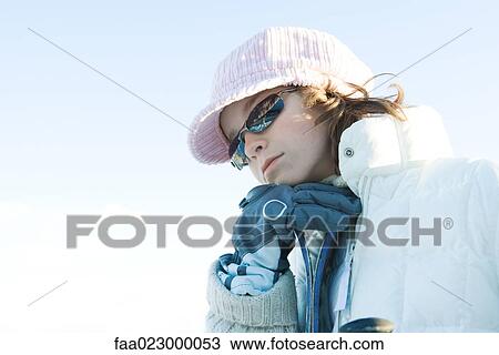 Young skier leaning on skis, hand under chin, looking down View Large Photo Image Stock Image - Young skier leaning on skis, hand under chin, looking down. Fotosearch