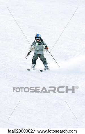 Young skier on ski slope, full length View Large Photo Image Stock Photo - Young skier on ski slope, full length. Fotosearch