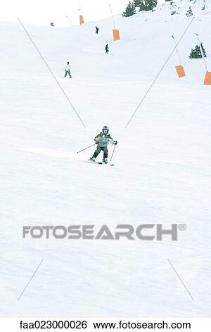 Young skier on ski slope, full length, in the distance View Large Photo Image Stock Photograph - Young skier on ski slope, full length, in the distance. Fotosearch