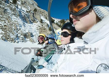 Young skiers on chair lift, side view, close-up View Large Photo Image Stock Photography - Young skiers on chair lift, side view, close-up. Fotosearch