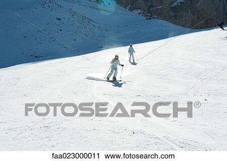 Young skiers on ski slope, full length, in the distance View Large Photo Image Stock Image - Young skiers on ski slope, full length, in the distance. Fotosearch