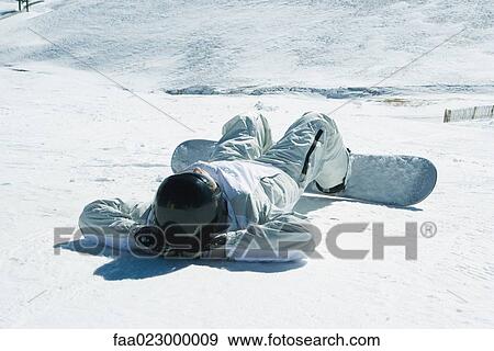 Young snowboarder lying on back in snow, hands behind head, full length View Large Photo Image Stock Photo - Young snowboarder lying on back in snow, hands behind head, full length. Fotosearch