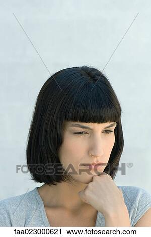 Young woman hand under chin, looking away, portrait View Large Photo Image Stock Image - Young woman hand under chin, looking away, portrait. Fotosearch