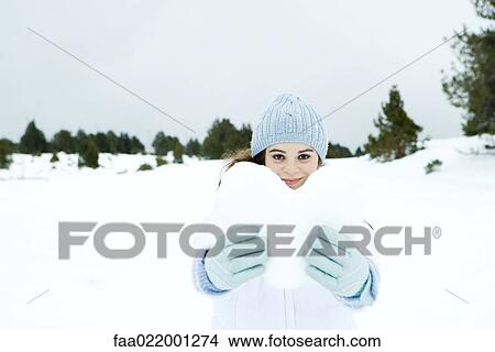 Young woman holding heart made out of snow, in snowy landscape View Large Photo Image Picture - Young woman holding heart made out of snow, in snowy landscape. Fotosearch