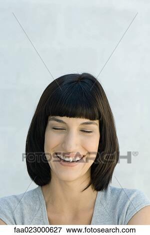 Young woman laughing, eyes closed, portrait View Large Photo Image Stock Photo - Young woman laughing, eyes closed, portrait. Fotosearch