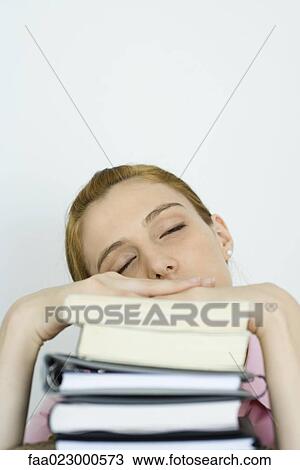 Young woman leaning on stack of books, eyes closed View Large Photo Image Stock Image - Young woman leaning on stack of books, eyes closed. Fotosearch