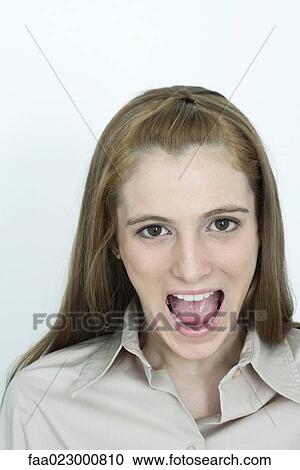 Young woman looking at camera with mouth wide open, portrait View Large Photo Image Stock Image - Young woman looking at camera with mouth wide open, portrait. Fotosearch