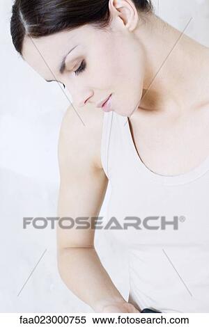 Young woman looking down, profile, portrait View Large Photo Image Stock Photography - Young woman looking down, profile, portrait. Fotosearch
