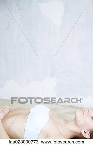 Young woman lying on back, eyes closed, dressed in tubetop View Large Photo Image Stock Image - Young woman lying on back, eyes closed, dressed in tubetop. Fotosearch