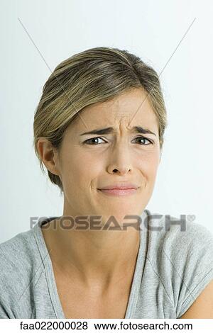 Young woman making face, portrait View Large Photo Image Stock Photo - Young woman making face, portrait. Fotosearch