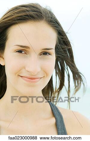 Young woman smiling at camera, portrait View Large Photo Image Stock Photo - Young woman smiling at camera, portrait. Fotosearch